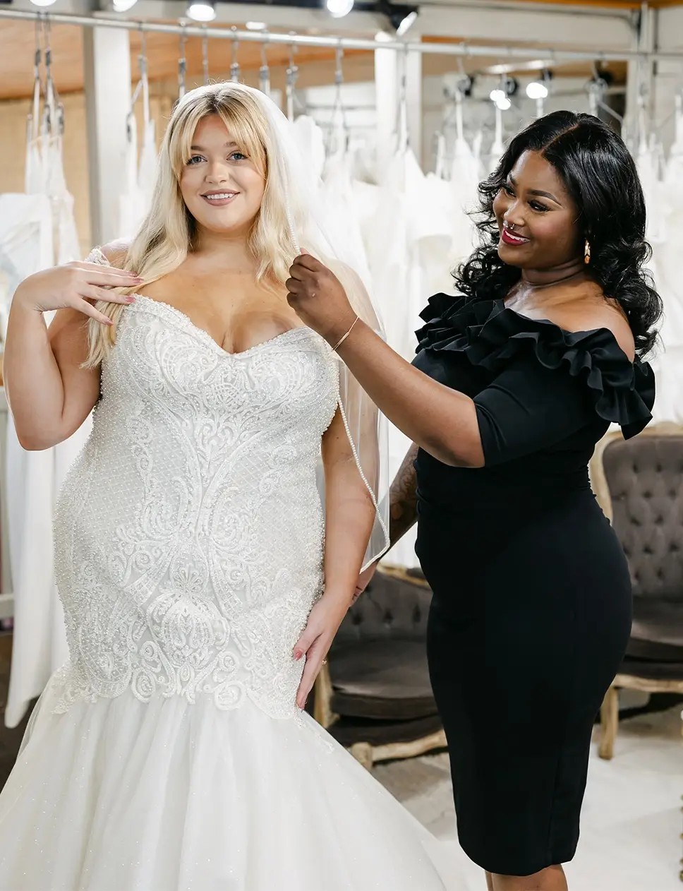 Smiling model wearing a white gown